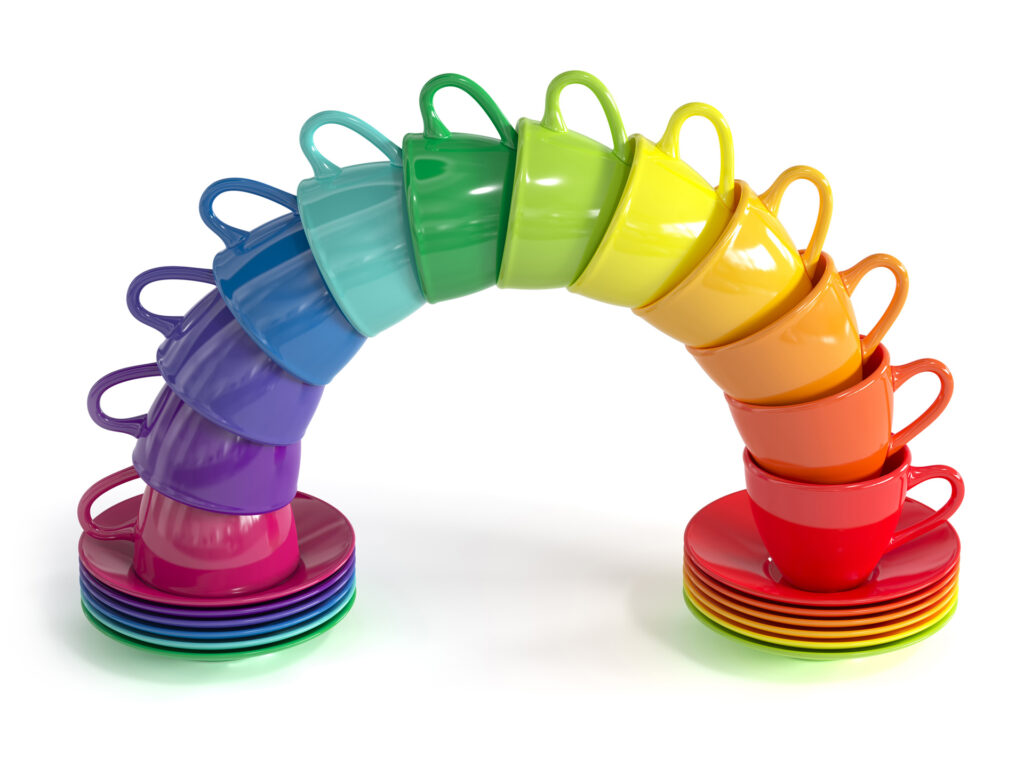 Multicolor teacups stacked together to form a rainbow